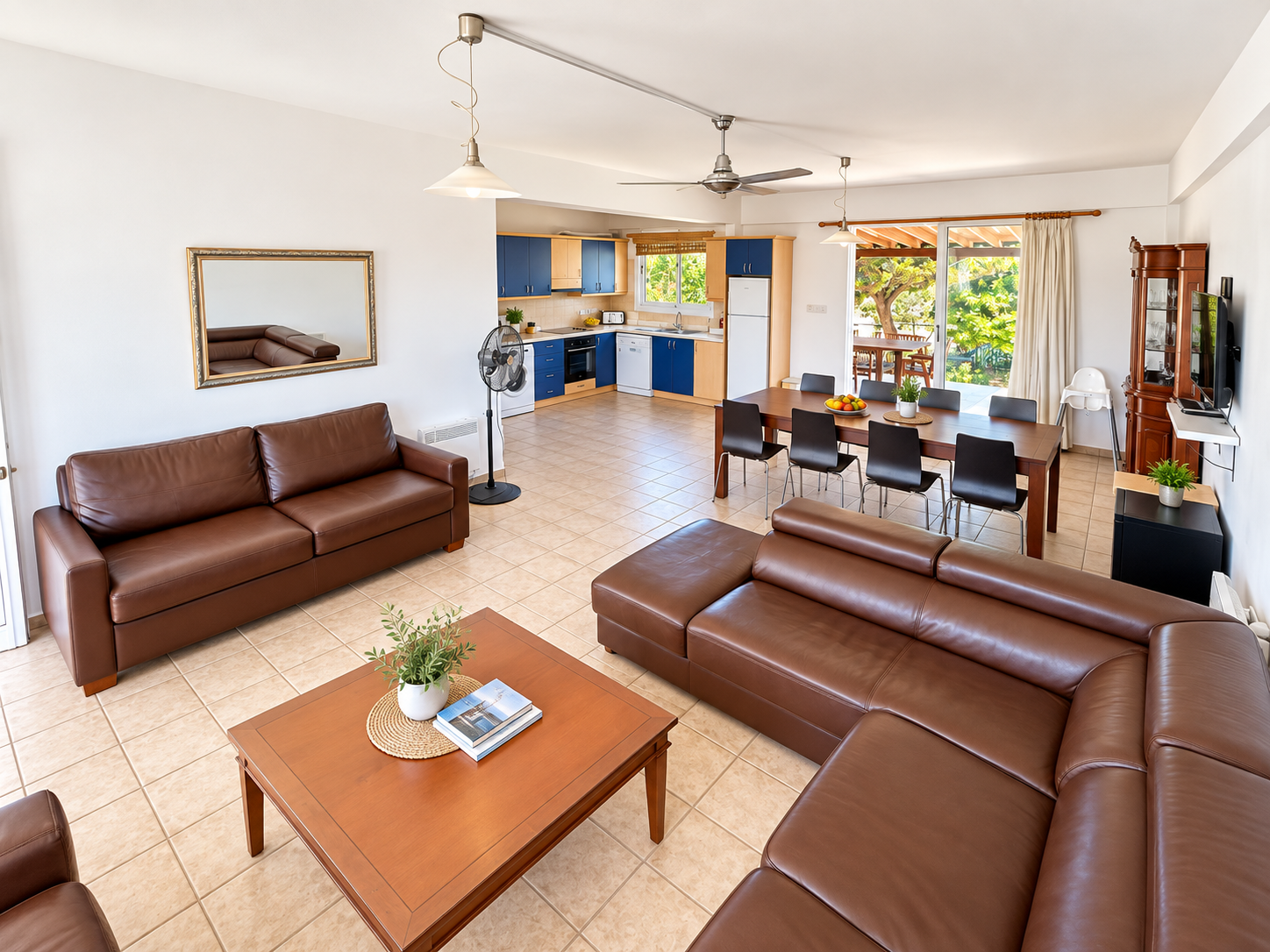 A lounge with two brown sofas and a coffee table beside a dining area